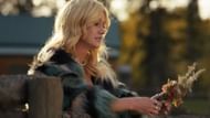 Heather reflects on her new responsibilities while holding wildflowers. (Image via CW)